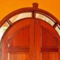 Arched entrance door with glass, full surround light. Mahogany
