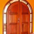 Arched entrance door with glass, full surround light. Mahogany