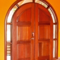 Arched entrance door with glass, full surround light. Mahogany