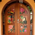 Arched entrance door with glass, full surround light. Full painted carving. Mahogany