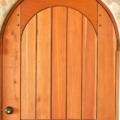 Full arch plank style mahogany door with wooden pegs