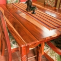 Dining table and chair set. Made of granadillo. Hand carved legs. Padded seat and back