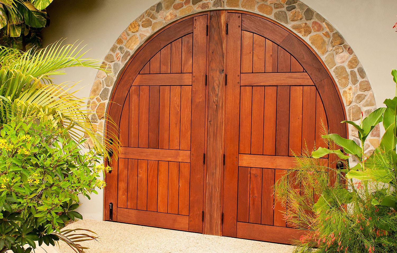 Large plank style full arch mahogany door with center post