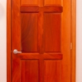 Standard six panel walk-through door, natural finish, figured mahogany